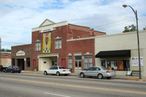 A street with cars parked in front of a theater in St George, South Carolina